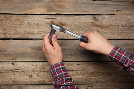 Auto mechanic with torque wrench at wooden table, closeupの写真素材