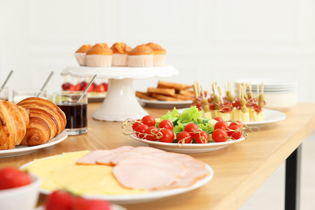 Different meals served on wooden table indoors, selective focus. Buffet menuの写真素材