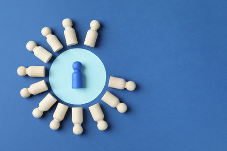 Bright piece among wooden ones on blue background, top view. Space for textの写真素材