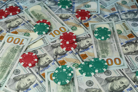 Many dollar banknotes and casino chips as background, closeupの写真素材