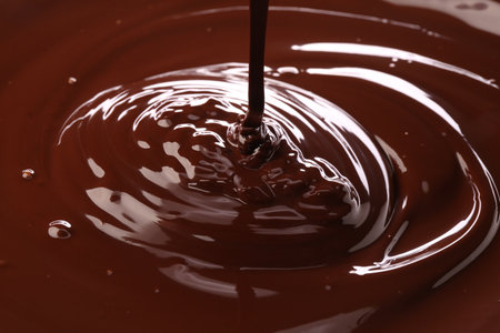Closeup view of pouring delicious melted chocolateの写真素材