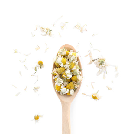 Chamomile flowers in wooden spoon isolated on white, top viewの写真素材