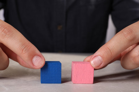 Woman with colorful cubes at light table, closeup