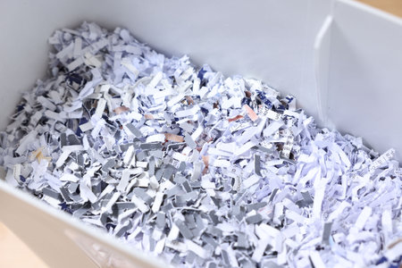 Shredded paper strips in bin, closeup viewの写真素材