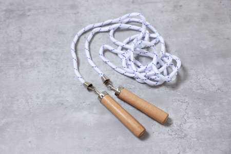 Skipping rope on gray table. Sports equipment