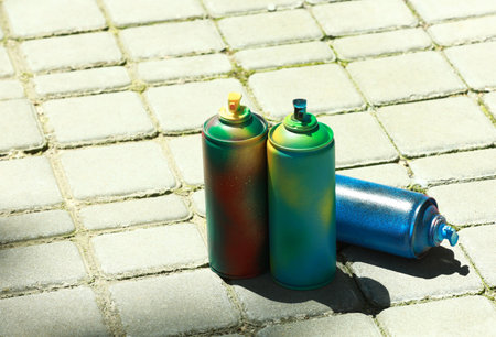 Many spray paint cans outdoors on sunny day, space for textの写真素材