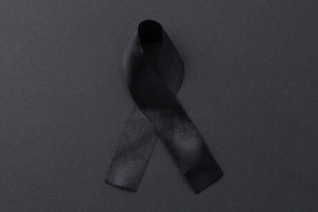 Black awareness ribbon on color background, top viewの写真素材