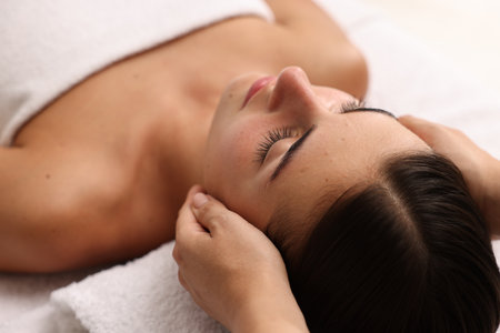 Attractive woman enjoying face massage, closeup. Beauty procedureの写真素材