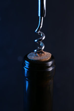Wine bottle with corkscrew on dark background, closeupの写真素材