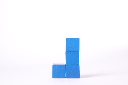 Many blue wooden cubes isolated on whiteの写真素材