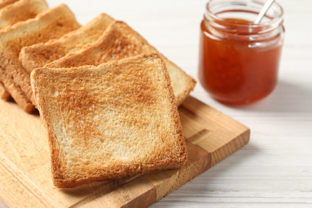 Delicious toasts and jam on white wooden table, closeupの写真素材