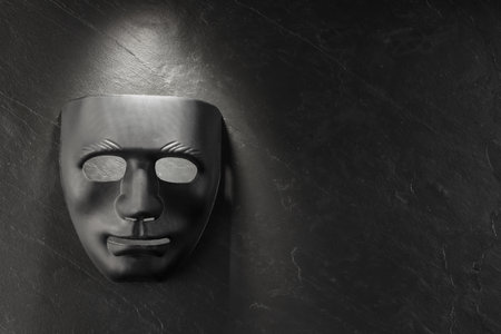 Plastic face mask on black slate surface, top view and space for text. Theatrical performanceの写真素材