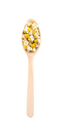 Chamomile flowers in wooden spoon isolated on white, top viewの写真素材