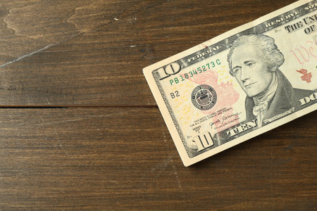 Stack of dollar banknotes on wooden table, top view. Space for textの写真素材