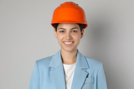 Engineer in hard hat on grey backgroundの写真素材