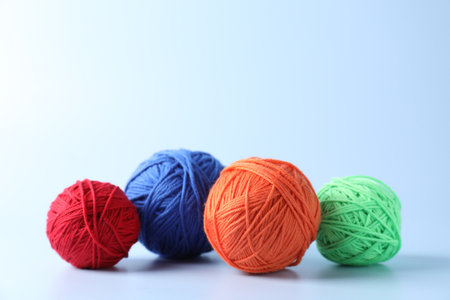 Different colorful yarns on light background. Space for textの写真素材