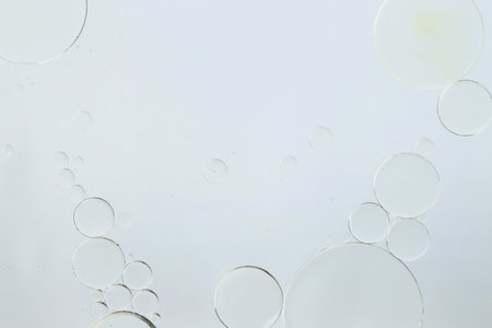 Sample of cosmetic oil on white background, macro view