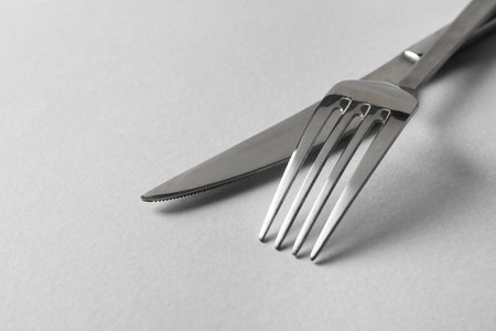 Stylish silver cutlery on white background, closeup