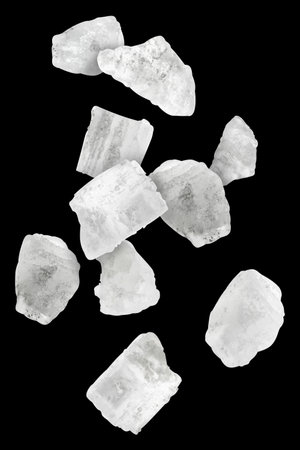 Sea salt crystals in air on black background