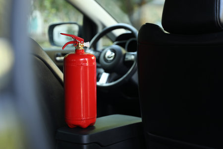 Red fire extinguisher in automobile. Car safety equipmentの写真素材