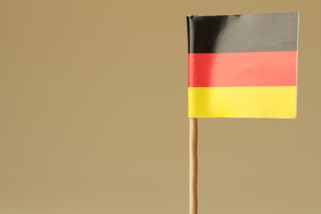 Small paper flag of Germany on beige background, closeup. Space for textの写真素材