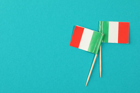 Small paper flags of Italy on light blue background, top view. Space for textの写真素材
