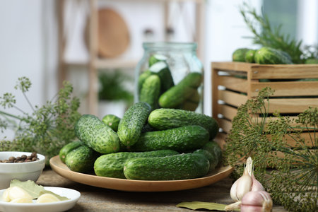 Fresh cucumbers, dill and spices on wooden table, closeup. Preparation for picklingの写真素材