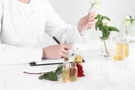 Aromatherapy product. Scientist developing essential oils at white table in laboratory, closeupの写真素材