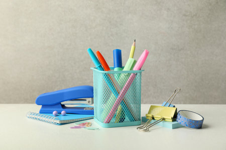 Stapler, holder and other different stationery on white tableの写真素材