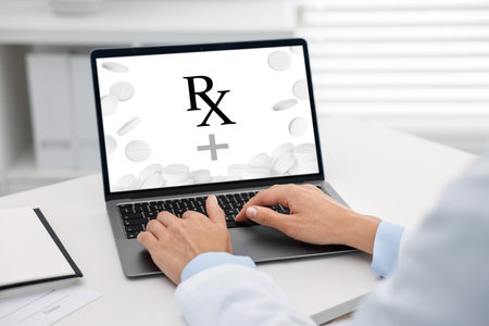 Medical prescription. Doctor working on laptop at table in clinic, closeupの写真素材