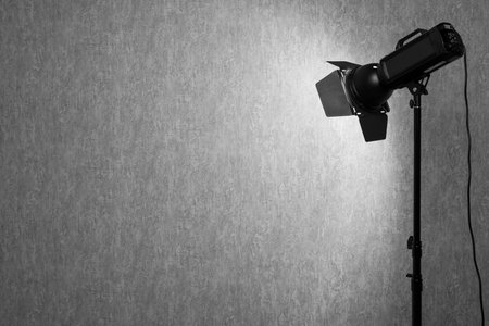 Gray photo background and professional lighting equipment in studio, space for textの写真素材