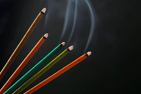 Aromatic incense sticks smoldering on black backgroundの写真素材