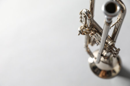 Closeup view of shiny trumpet on light gray background, space for text. Wind musical instrumentの写真素材