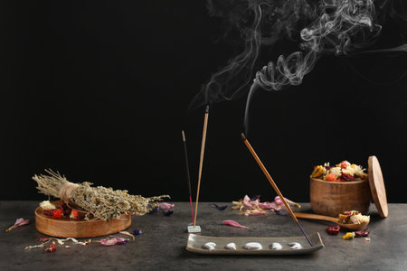 Aromatic incense sticks smoldering on gray tableの写真素材