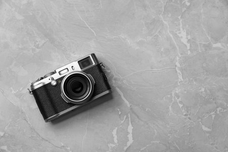 Vintage photo camera on gray marble table, top view. Space for textの写真素材