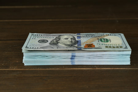 Stack of dollar banknotes on wooden tableの写真素材