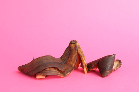 Banana peel with dark spots on pink backgroundの写真素材