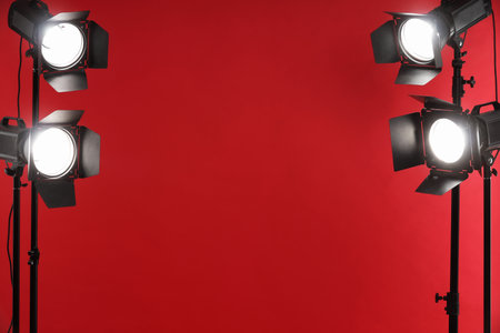 Red photo background and professional lighting equipment in studio