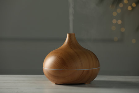 Aroma oil diffuser on white wooden tableの写真素材