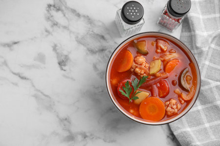 Tasty homemade stew with vegetables on white marble table, flat lay. Space for textの写真素材
