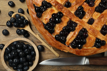 Tasty homemade pie with blueberries served on wooden table, flat layの写真素材