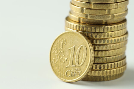 Stacked euro coins on white background, closeup. Space for textの写真素材