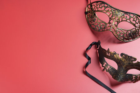 Beautiful carnival masks on red background, top view. Space for textの写真素材