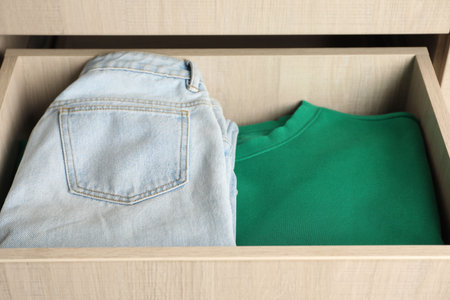 Chest of drawers with different folded clothes, closeupの写真素材
