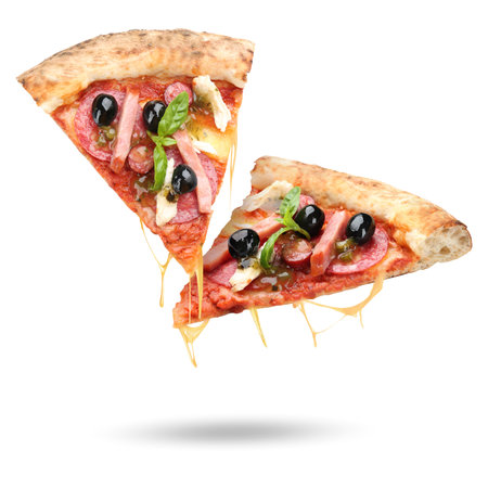 Slices of delicious pizza in air on white backgroundの写真素材