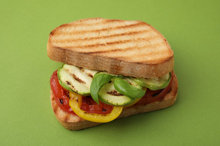 Tasty sandwich with grilled vegetables on green background, closeupの写真素材