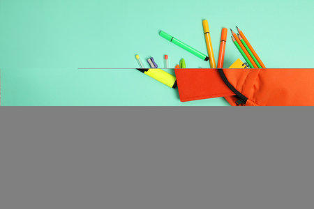 Backpack and different school supplies on turquoise background, flat lay. Space for textの写真素材