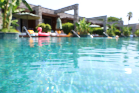 Blurred view of outdoor swimming pool at luxury resortの写真素材
