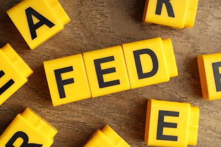 Cubes with letters Fed (Federal Reserve System) on wooden table, flat lay