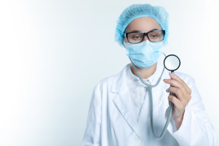 Doctor holding stethoscope on white background, selective focus. Space for textの写真素材